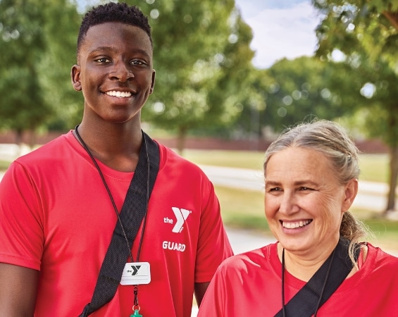 Participants in Lifeguard, AED, First Aid, and CPR certifications at the YMCA of Central Virginia. A man and woman lifeguard wearing matching outfits.