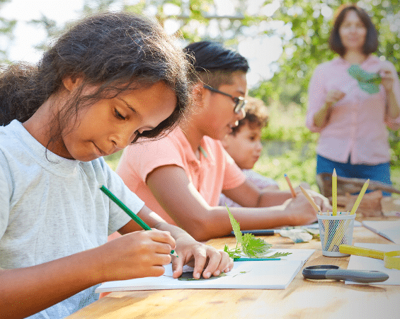 group of kids at a table for art camp | family wellness
