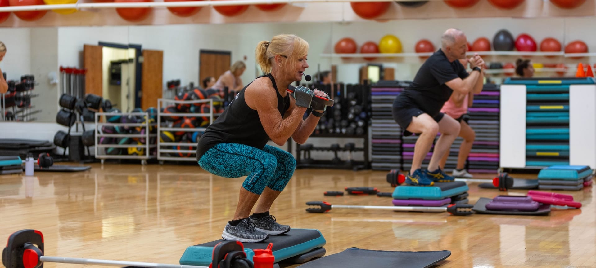 a woman squatting with a microphone