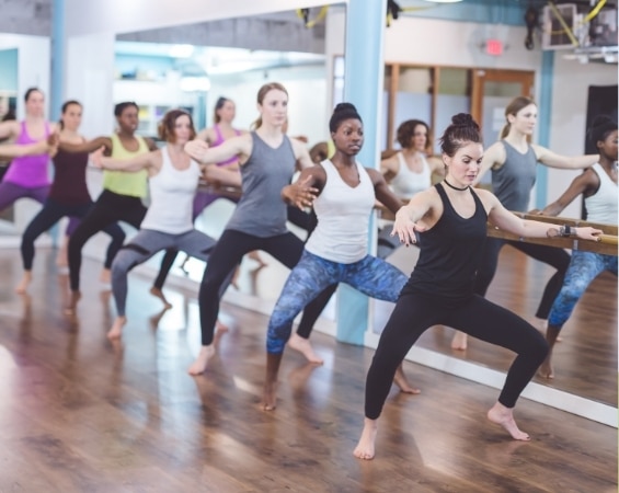 a group of women in a Barre dance class