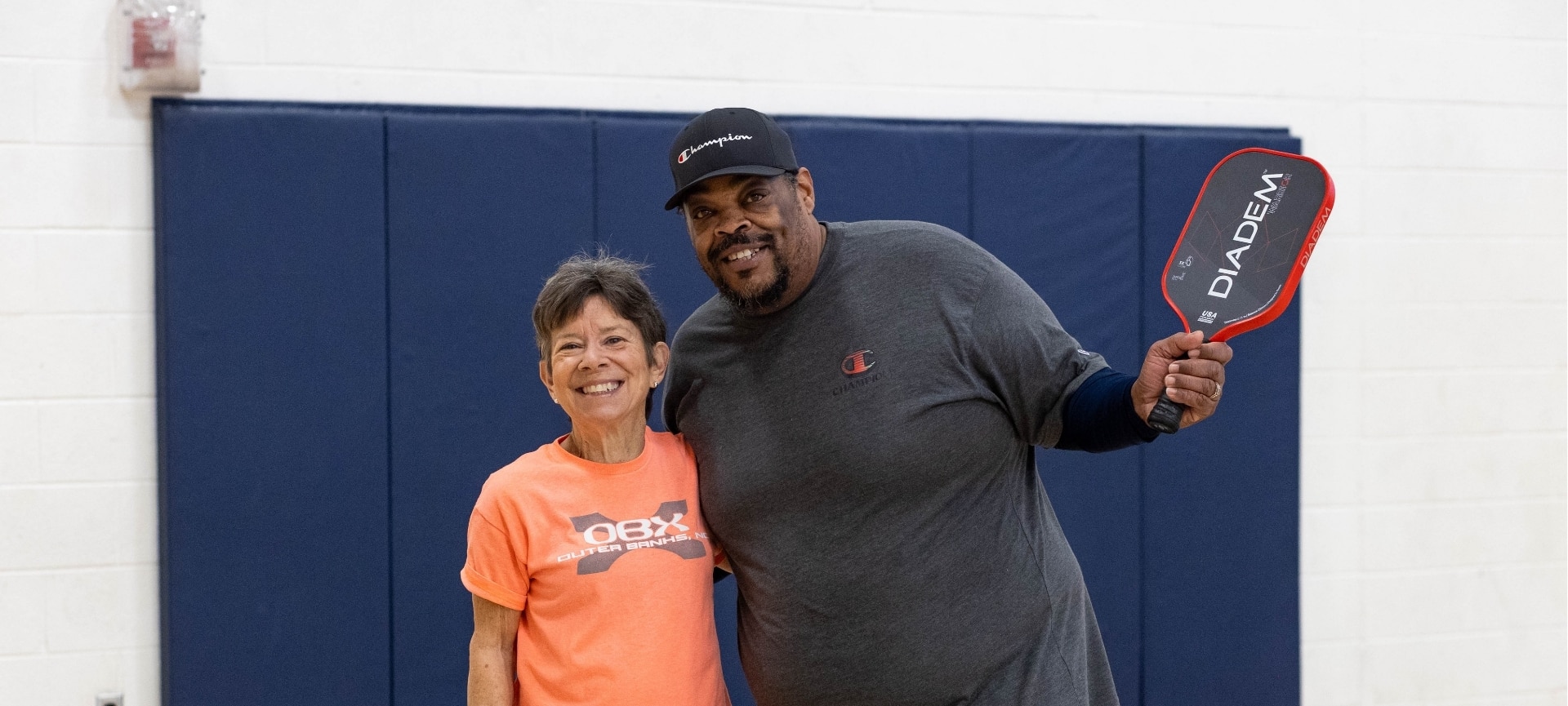 a man and woman standing together | adult sports