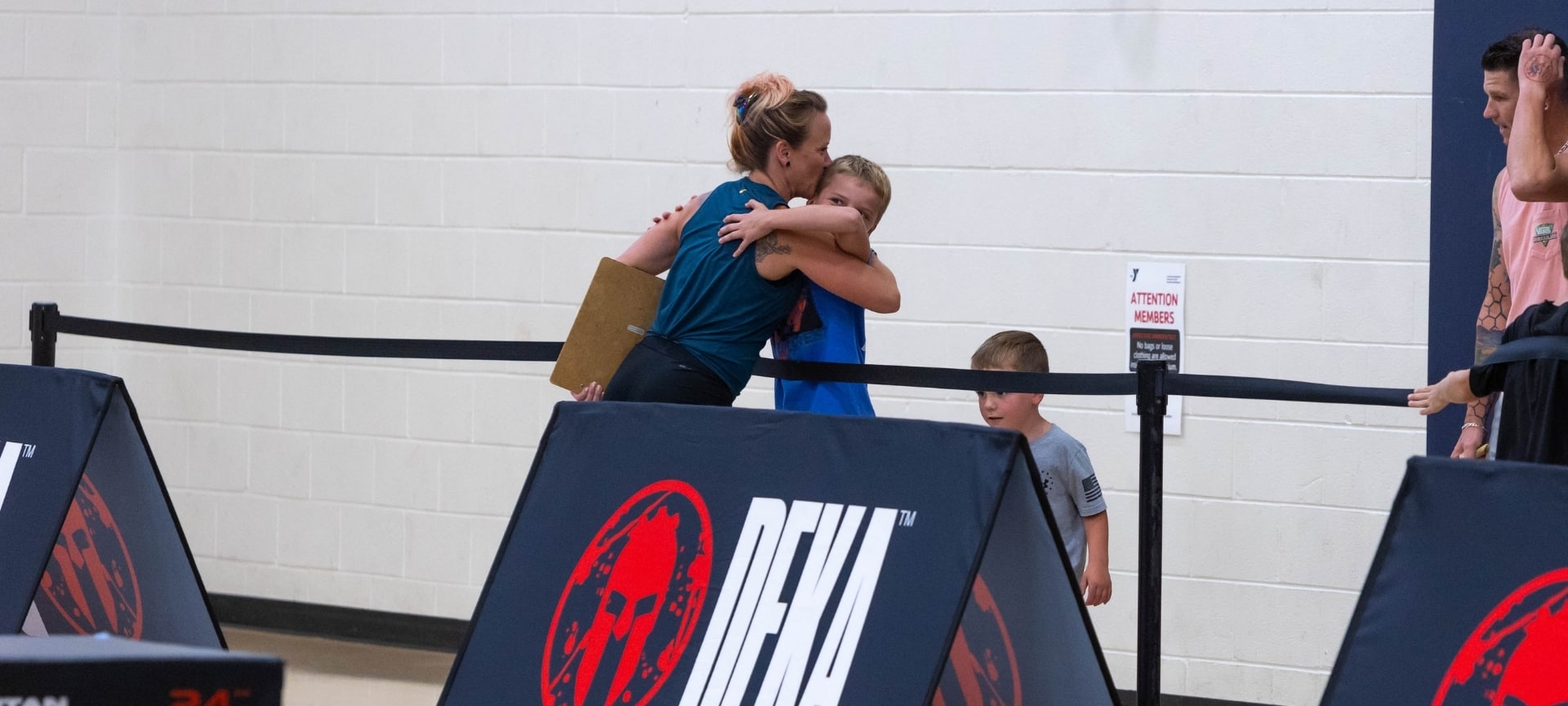 a woman hugging a boy