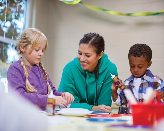 a woman and kids painting