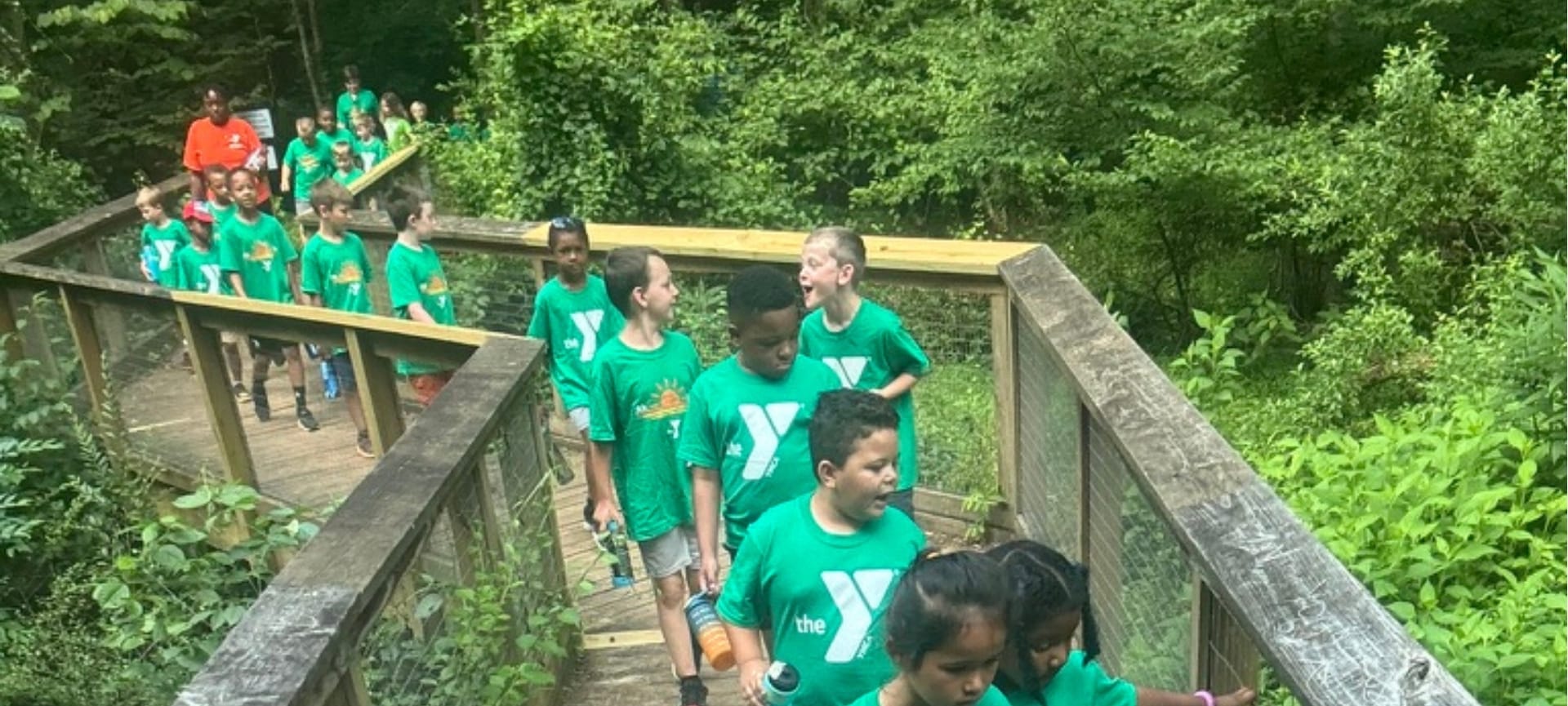 a group of kids in green shirts