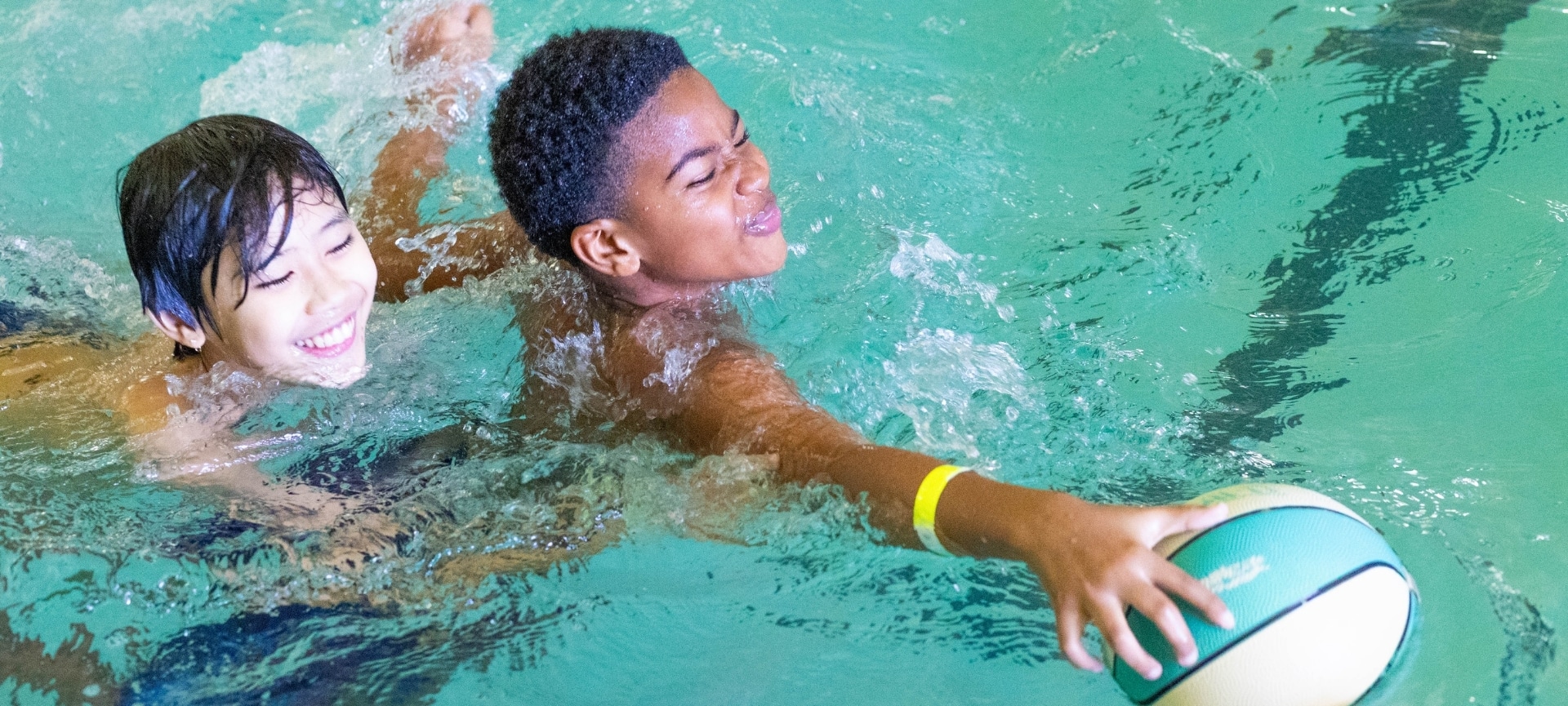 a boy swimming in a pool