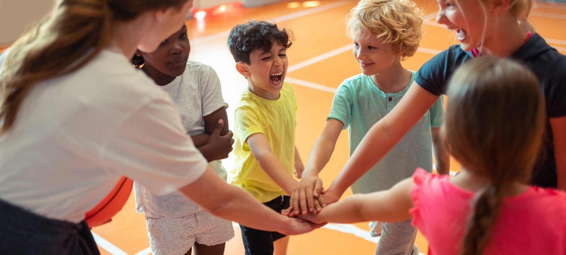 a group of kids holding hands together