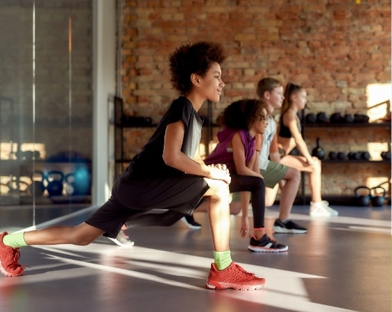 a group of kids doing stretching exercises