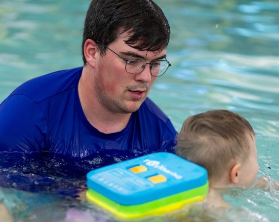 a man in a swimming pool with a child