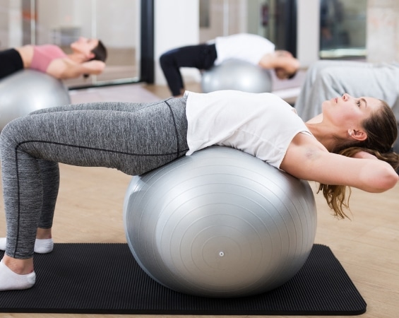a group of people exercising on exercise balls