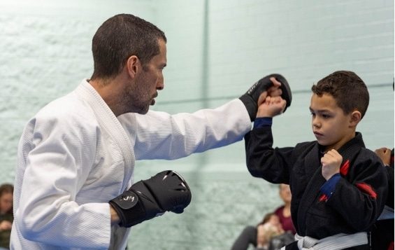a man and boy in jiu jitsu / karate uniforms