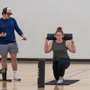 Woman lunging during DEKA Strong