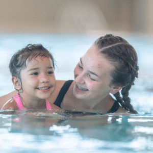 Woman and child swimming together.